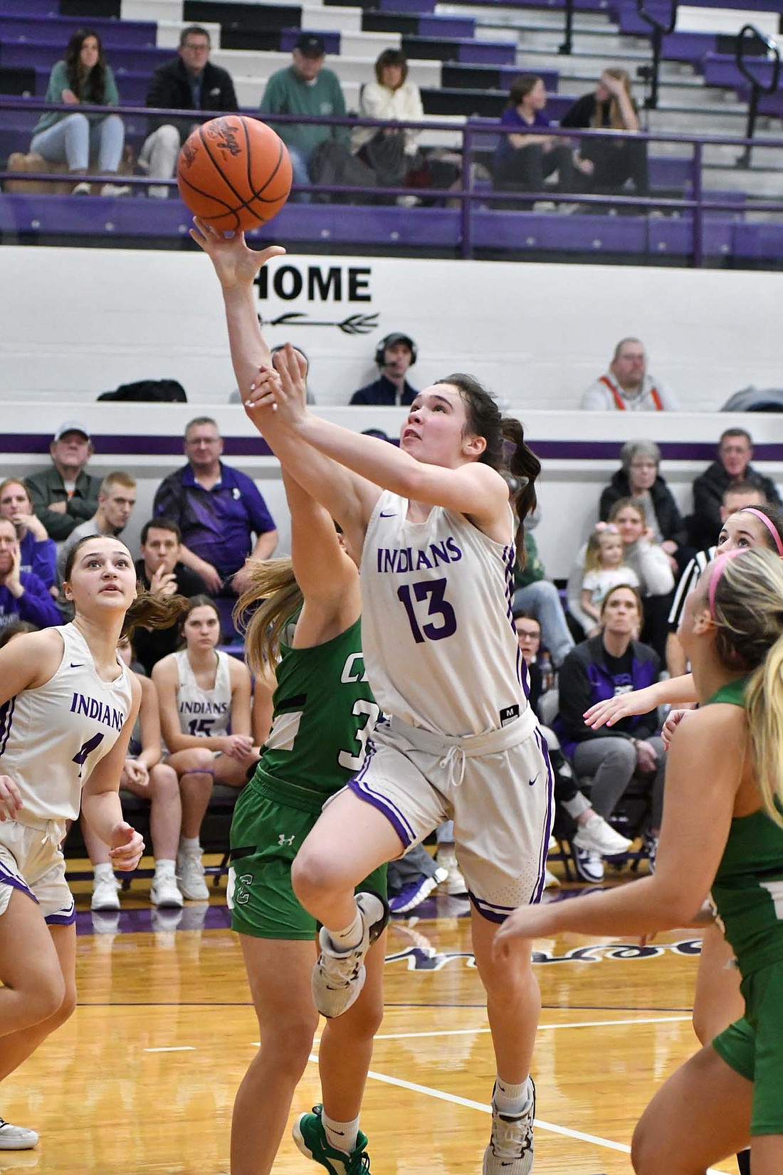 Fort Recovery High School freshman Cameron Muhlenkamp gets fouled by Celina's Kate Braun on a step through Monday during the Indians' 47-43 win. Muhlenkamp completed the three-point play as part of a career day with 14 points. (The Commercial Review/Andrew Balko)