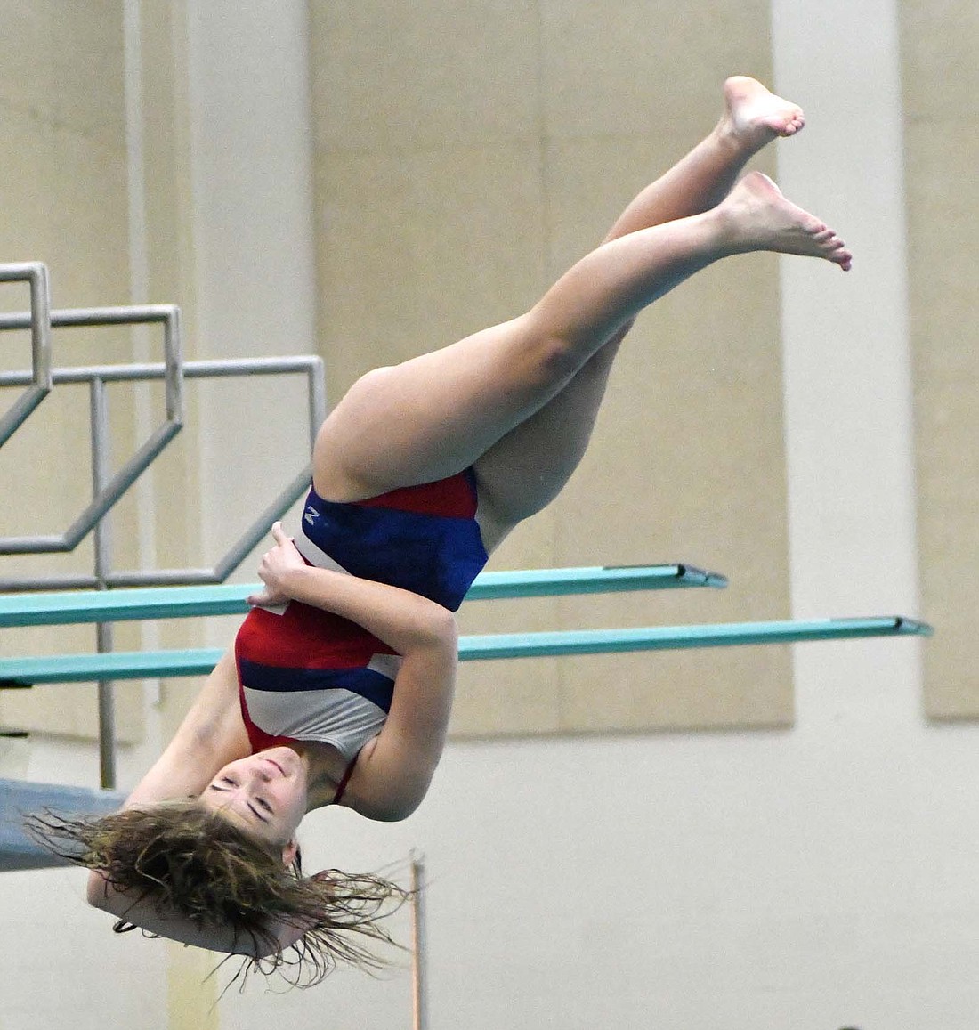 Jay County High School junior Maddy Snow twists in midair during her forward somersault 1 twist at the regional diving meet at South Side on Tuesday. The attempt netted Snow 30.4 points, as she finished with 221.2 total on the day. (The Commercial Review/Andrew Balko)