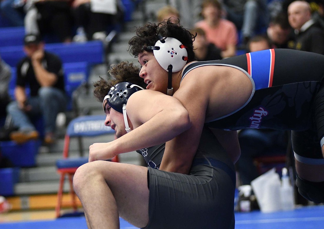 Jay County High School sophomore Alan Ortiz, a 215-pounder, controls Ethan Michael of Norwell during their third-place match Saturday in the regional tournament. Ortiz is one of seven Patriots who will compete in the semi-state tournament beginning at 8:30 a.m. Saturday at Allen County War Memorial Coliseum in Fort Wayne. (The Commercial Review/Ray Cooney)