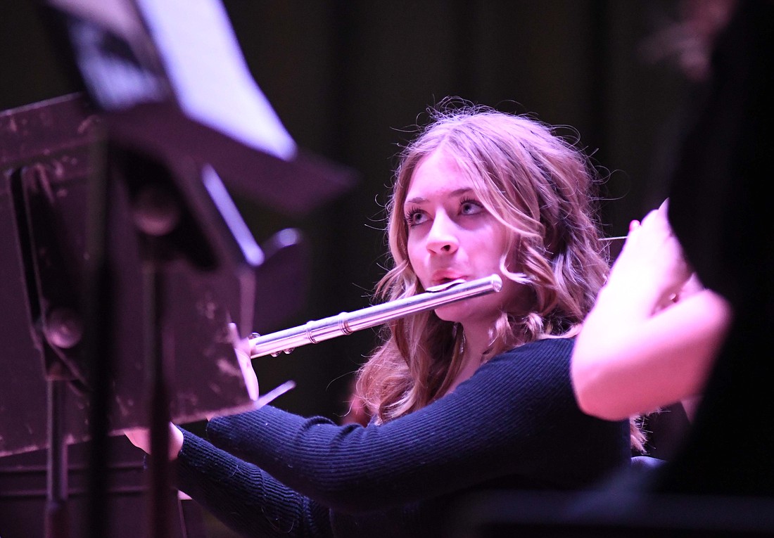 Brakella Sturgill of the Jay County Junior High School band keeps her eyes on the director while playing the flute Sunday during the Winter Pops Concert. The seventh and eighth graders performed “Colliding Visions” and “Castles and Dragons.” They later returned to join the high school band for a performance of “Crazy for Cartoons.” (The Commercial Review/Ray Cooney)