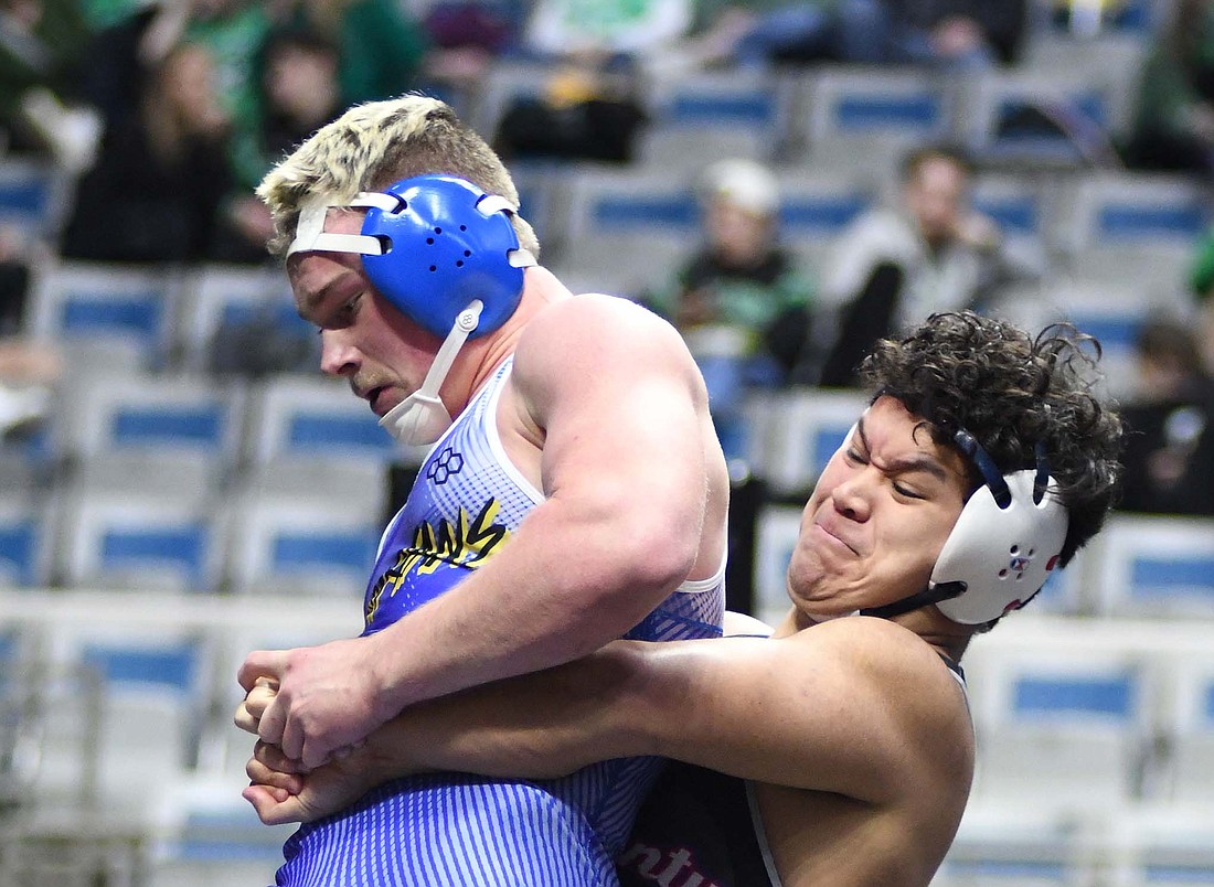 Jay County High School sophomore Alan Ortiz lifts Caleb Evans of Homestead off the mat during the opening-round match Saturday in the 215-pound bracket in the semi-state tournament at Allen County War Memorial Coliseum in Fort Wayne. Ortiz edged Evans 5-3 before falling by pin to eventual champion No. 18 Travis Henke of Northridge by a last-second pin in the ticket round to finish his season with a 24-9 record. (The Commercial Review/Ray Cooney)