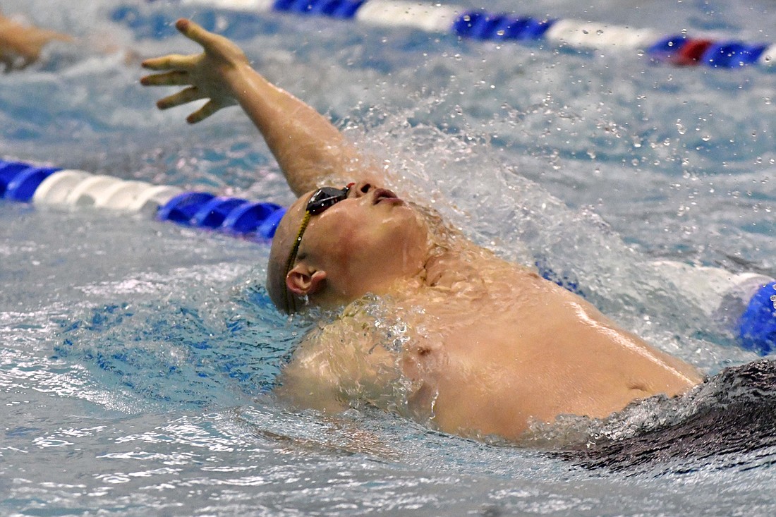 Jay County High School sophomore Matthew Fisher swims the 100-yard backstroke Saturday as the sole finalist for the Patriots at the IHSAA sectional swim meet hosted at Jay County. Fisher finished the race in 1 minute, 6.12 seconds, to take eighth place, the second highest of any Patriot in the sectional after Bryden Carter’s fifth-place finish in the 1-meter diving. (The Commercial Review/Ray Cooney)