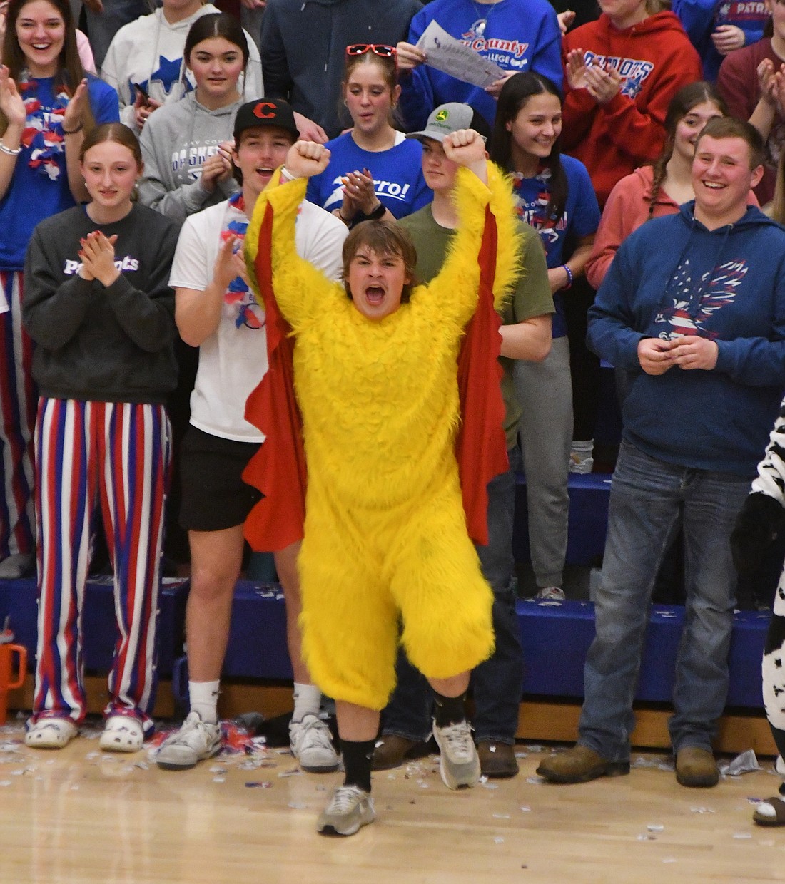 Garrett Bennett, a sophomore at Jay County High School, cheers in celebration of his classmates Tony Wood and Cody Rowles, who were being recognized during halftime of the JCHS boys basketball game  Tuesday for medaling at the state wrestling tournament. Bennett was dressed as a chicken as Jay County FFA had various activities during the game as part of its celebration of National FFA Week. (The Commercial Review/Andrew Balko)