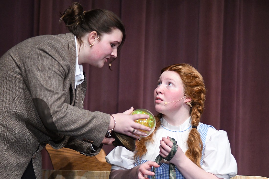 Joscie LeFevre (right) as Dorothy Gale gives a concerned look as Professor Marvel, played by Grace Lochtefeld, consults a crystal ball during Tuesday’s rehearsal for Fort Recovery Drama Club’s production of “The Wizard of Oz.” Shows are 7 p.m. Friday and Saturday as well as 2 p.m. Sunday. Tickets, which will be available at the door, are $6 for students and $8 for adults, with children 5 and younger admitted free. (The Commercial Review/Ray Cooney)