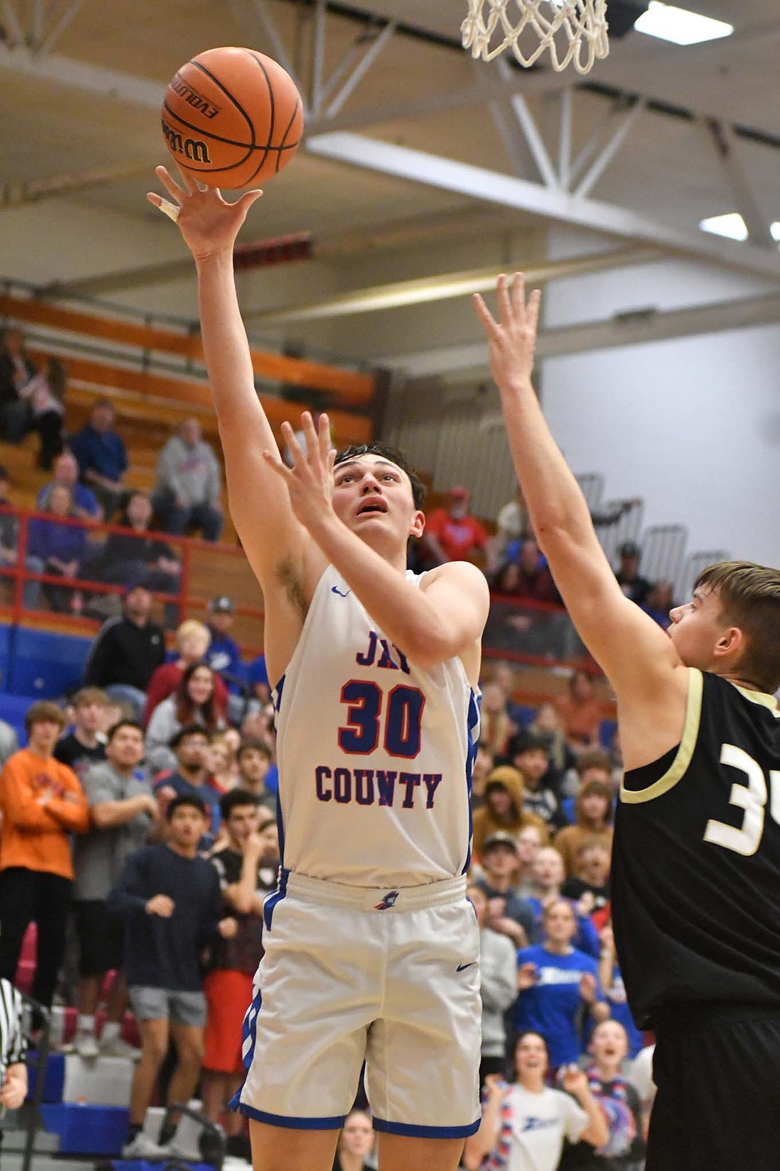 Aiden Phillips, a Jay County High School sophomore, puts up the winning layup for the Patriots as they downed Winchester 47-45 on Tuesday. Phillips ducked in to receive a pass from Parker Nichols with less than 5 seconds left to put the Patriots on top. (The Commercial Review/Andrew Balko)