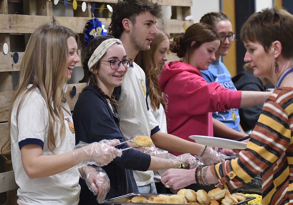 Gretchen Link laughs while serving a biscuit during Jay County FFA’s brownie breakfast for staff Thursday morning at Jay County Junior-Senior High School. (The Commercial Review/Ray Cooney)