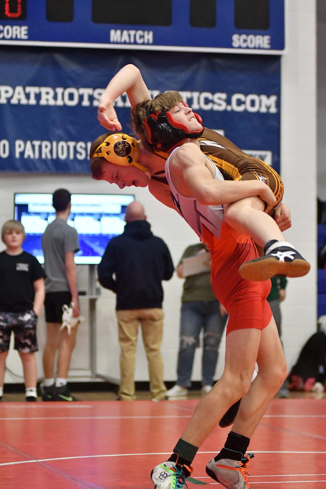 Walter Campofiore, a seventh-grader at Jay County Junior High School, picks up sixth-grader Jackson Ponder of Monroe Central during the quarterfinal match of the 106-pound bracket on Saturday. Campofiore won the match 10-6 before falling in the championship. (The Commercial Review/Andrew Balko)