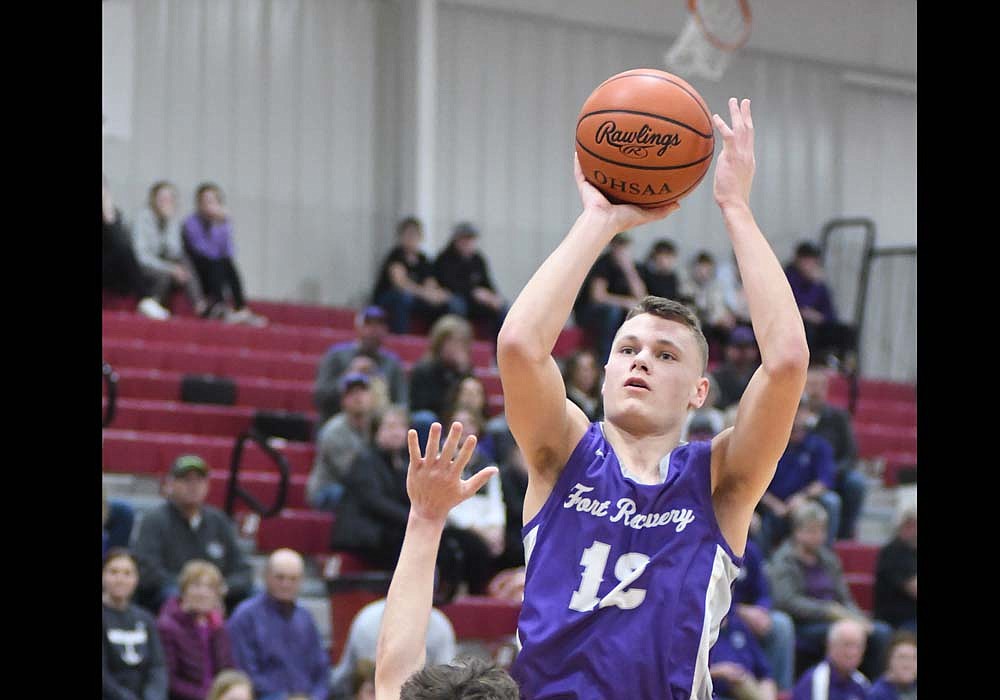 Fort Recovery High School senior Rex Leverette puts up a shot over Hunter Damron of host Upper Scioto Valley during the sectional opener Wednesday night. Leverette scored eight of his team-high 12 points in the third quarter, but the Indians' season came to an end with a 58-45 defeat. (The Commercial Review/Ray Cooney)