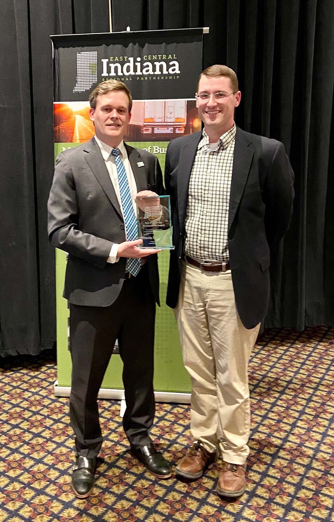 Travis Richards (right), executive director of Jay County Development Corporation, was honored recently with the East Central Indiana Pathfinder Partnership Award at the East Central Indiana Regional Partnership annual meeting. Trevor Friedeberg (left), president and CEO of the regional partnership, described Richards as an active contributor and voice for small communities who is responsive, thorough, organized, knowledgeable and a “top-notch ambassador for his county.” He “finds ways to forge a path toward regional prosperity even when the path is winding and not entirely stateforward,” Friedeberg said. (Photo provided)