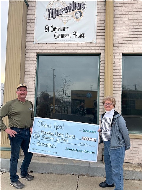 Fort Recovery Morvilius Opera House recently received a $10,000 donation from Nature’s Green Nursery for its restoration project. Pictured above are owner of Nature’s Green Nursery Steve Stone and his mother, Irene Stone, holding a large check in front of the opera house. The 1883 building at 101 N. Main St., Fort Recovery, is on the National Register of Historic Places. Local residents are working to restore the facility to be used as a community space. (Photo provided)