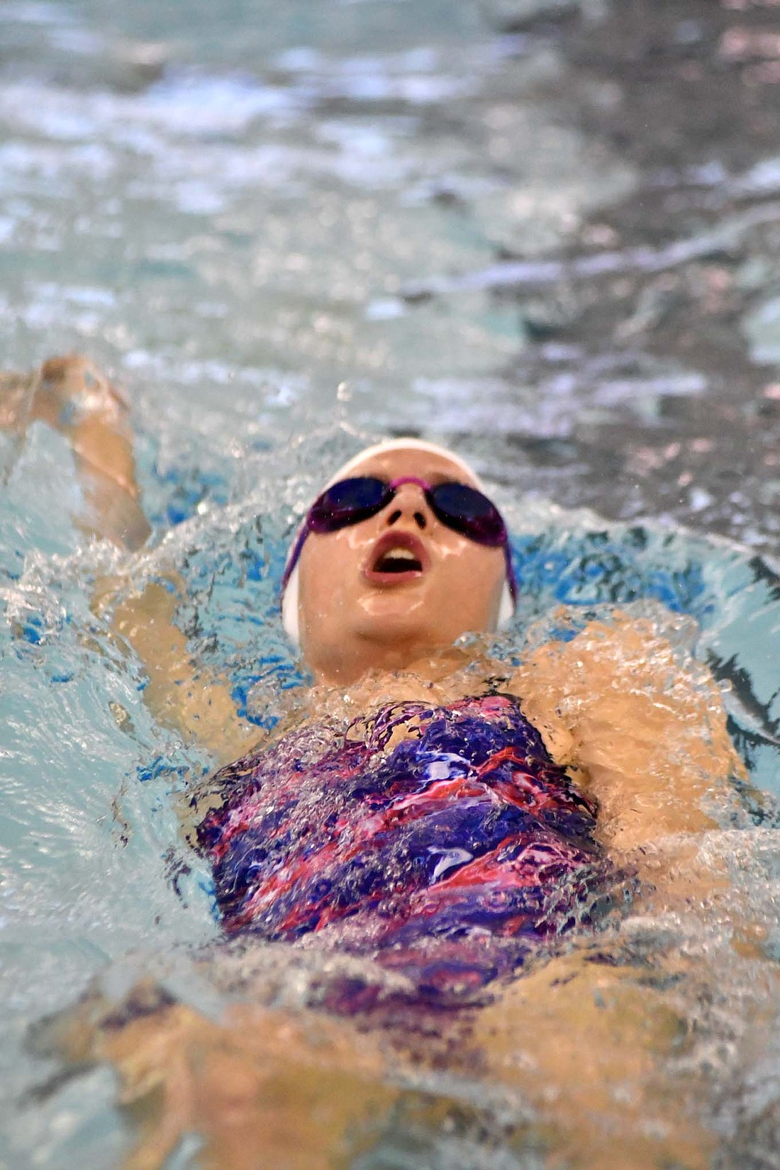 Elly Byrum swims the backstroke as part of the Jay County Junior High School’s 200-yard medley relay team during Thursday’s meet against Bluffton. (The Commercial Review/Andrew Balko)