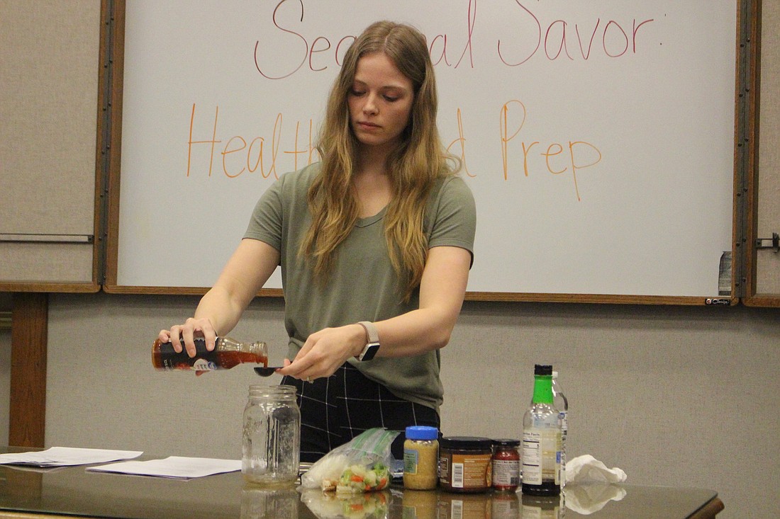 Registered dietician Malarie Krieg measures ingredients for a microwavable stir fry recipe Tuesday during the first session of the new adult healthy cooking mini series at Jay County Public Library. Krieg walked attendees through tips for eating healthy and shared healthy food preparation ideas, including samples and recipes for egg cups, energy balls and the stir fry pictured above. (The Commercial Review/Bailey Cline)