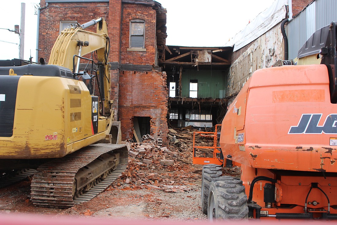 Demolition of the former Hunt’s building at 208 and 210 N. Meridian St., Portland, started this week. Pictured above, equipment sits Wednesday behind the building with debris scattered around the property. (The Commercial Review/Bailey Cline)