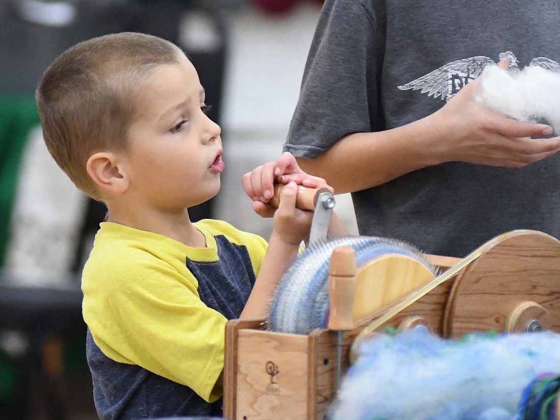 Gabe Stamets, 5, Monroeville, takes his turn using a spinner Friday at the Denise’s Fleeces booth during the Jay County Fiber Arts Festival at Jay Community Center in Portland. The festival continues from 9 a.m. to 4 p.m. today at the community center. (The Commercial Review/Ray Cooney)