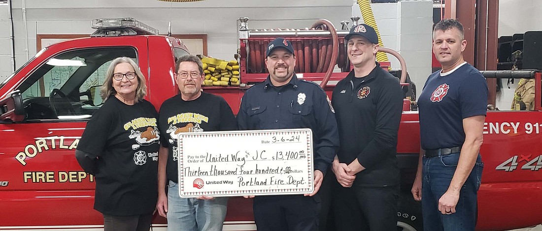 Portland Fire Department presented a check for $13,400 from the first Splashin' with a passion in memory of long time community volunteer, Peggy Atkinson, to the United Way of Jay County. Pictured are Cindy Denney and Troy Atkinson of United Way and  Portland firefighters Travis Theurer, Dustin Guggenbiller and Mike Weitzel. (Photo provided)