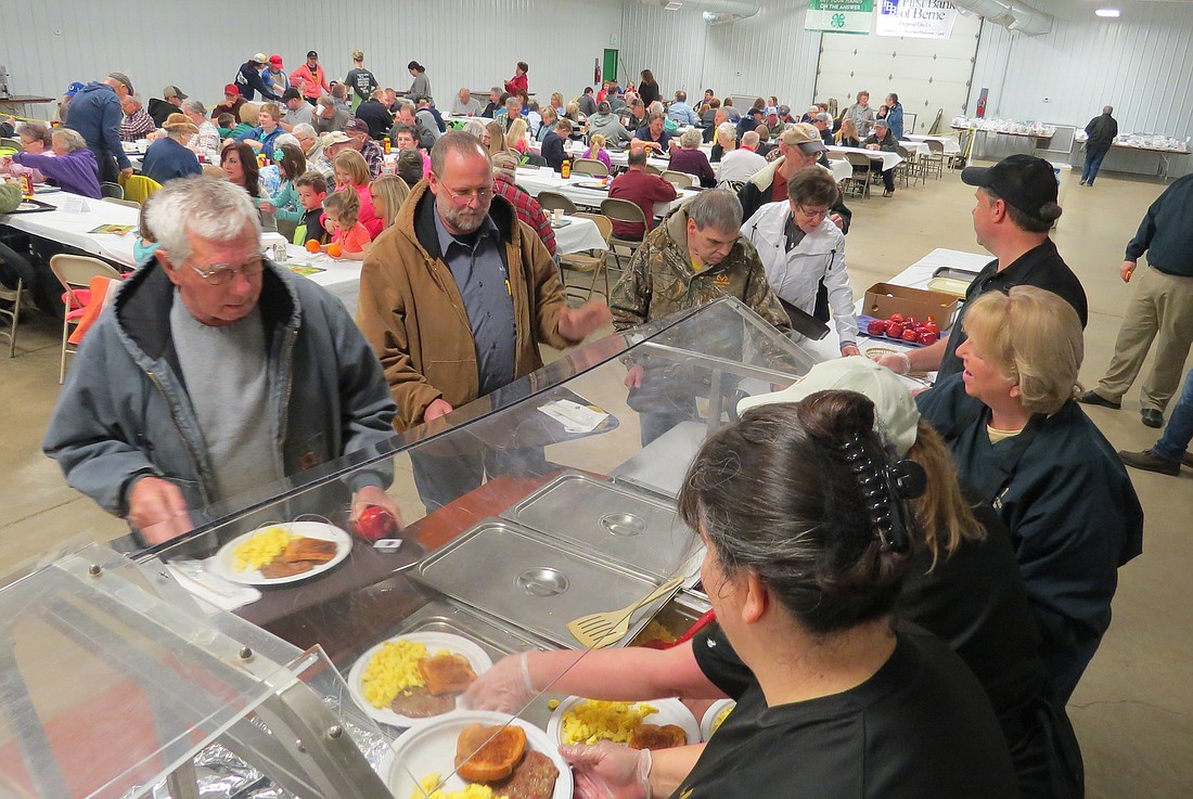 Attendees line up to get their eggs, sausage and toast with a full room behind them for the 2017 Ag Day Breakfast. The event will return in its full format this year after being dormant since the coronavirus pandemic forced cancellation in 2020. The breakfast was held last year, but it was limited to coffee and donuts. This year, a full breakfast of sausage, eggs, toast and beverages will be available for $1. (The Commercial Review/Ray Cooney)