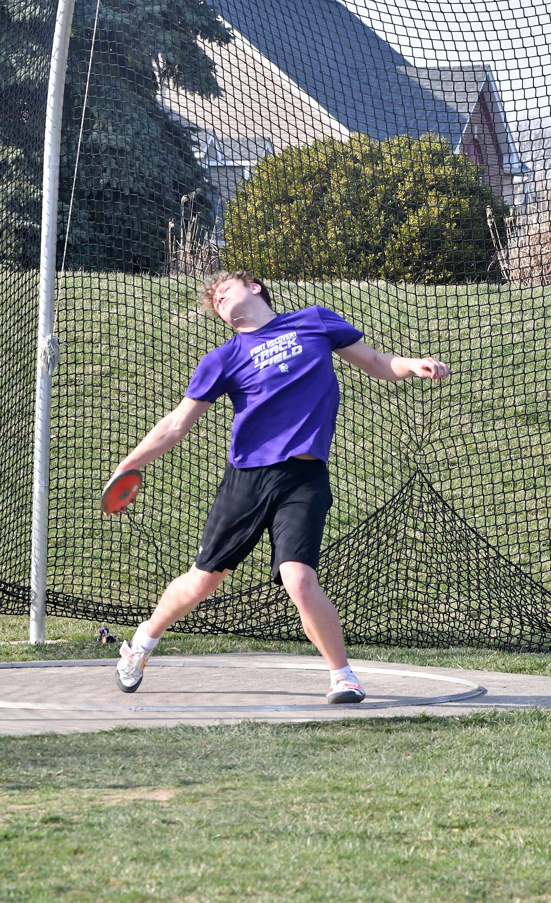 Carson Fullenkamp, a Fort Recovery High School sophomore, gets in a couple of discus throws at the end of practice Wednesday. The Indians open their season March 26, before the home opener on April 2. (The Commercial Review/Andrew Balko)