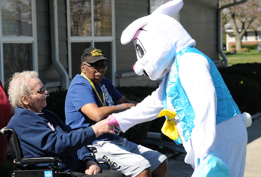 Resident Marilyn Pearson shakes hands with the Easter Bunny on Saturday afternoon. The visit was part of the annual community Easter egg hunt at Persimmon Ridge Rehabilitation Centre in Portland. (The Commercial Review/Sam Murdock)