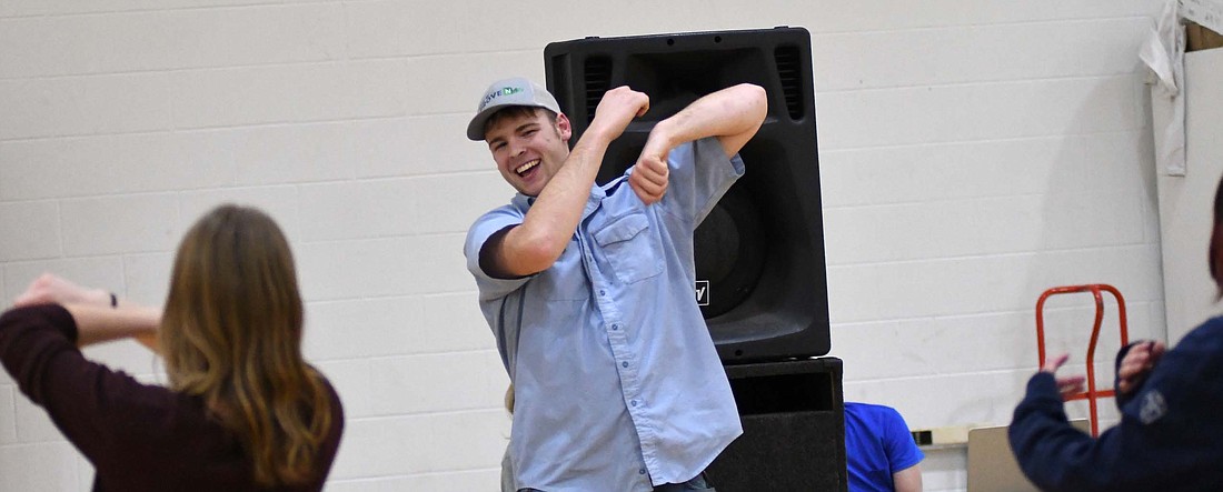 Jay County High School senior Ben Heath grins while dancing to V.I.C.’s “Wobble” with friends, including Hannah Boggs (foreground) during Tuesday’s student-teacher game night in the auxiliary gym. (The Commercial Review/Ray Cooney)