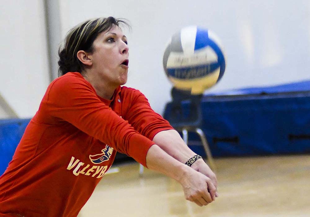 Jay County High School volleyball coach makes a pass during a match Wednesday evening as part of student-teacher game night in the auxiliary gym. (The Commercial Review/Ray Cooney)