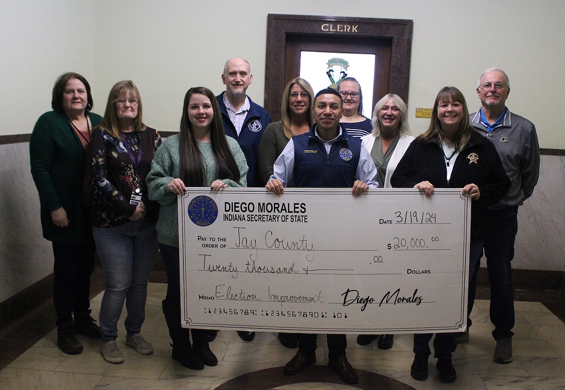 Jay County Clerk’s Office received a $20,000 grant Tuesday from Indiana Secretary of State Diego Morales’ office. The dollars will be used to create a new website for local voters to learn about candidates and election results. Pictured at left are clerk’s office employees with Morales (center) and Jay County Commissioner Rex Journay (at right). (The Commercial Review/Bailey Cline)