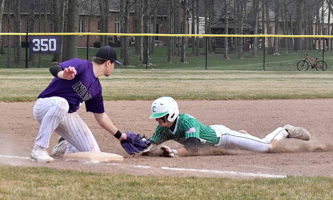 Fort Recovery High School junior Caden Grisez lays down a tag on Celina's Brodee Schulte-Arnold, who was caught stealing by Riggs Tobe in top of the fourth inning of Monday's season opener. The out helped the Indians maintain a one-run deficite, which they tied in the bottom of the inning before letting the game slip in the fifth. For more photos from the game visit thecr.com.
