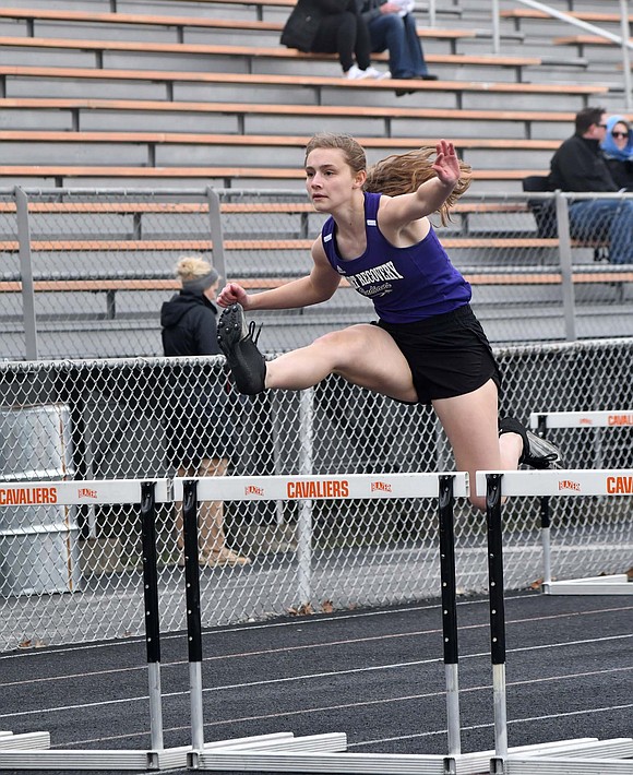 Fort Recovery High School sophomore Madison Heitkamp jumps over a hurdle during the March 26 meet at Coldwater. Despite being seeded ninth, Heitkamp ran a career best 18.39 seconds to finish fourth and score for the Indians. (The Commercial Review/Andrew Balko)
