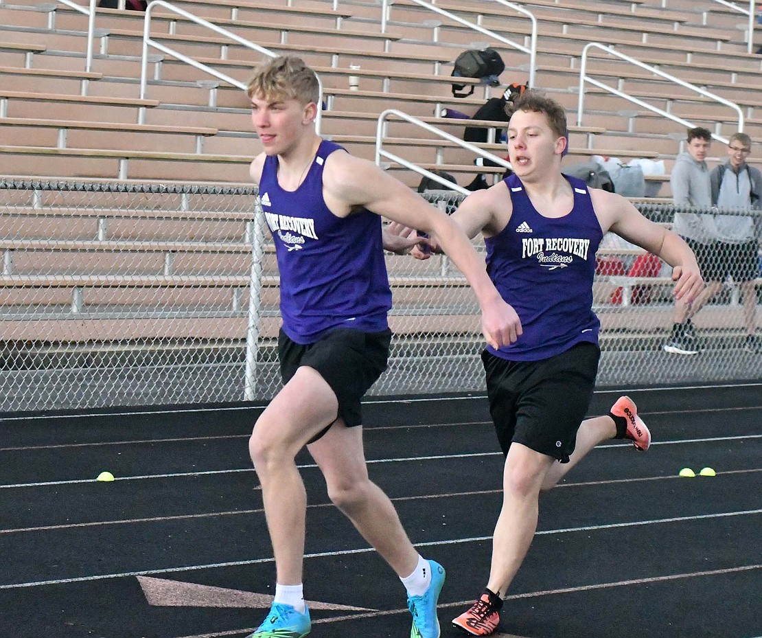 Fort Recovery High School sophomore Matthew Marchal hands off the baton to freshman Breaker Jutte during the March 26 meet at Coldwater. Marchal and Breaker made up two legs of the 4x200-meter relay that placed fifth with a time of 1 minute, 47.47 seconds. (The Commercial Review/Andrew Balko)