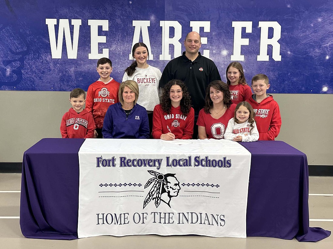 FRHS senior Paige Guggenbiller, pictured above in the center, signed her national letter of intent to join the Ohio State University women’s rowing team on Monday. Pictured front row from left are brother Noah, FRHS swim coach Mindy Bubp, Paige, mother Katie, sister Lucy, Paige and brother Bo. Back row are brother Andrew, sister Sophia, father Chris and sister Adeline. (Photo provided)