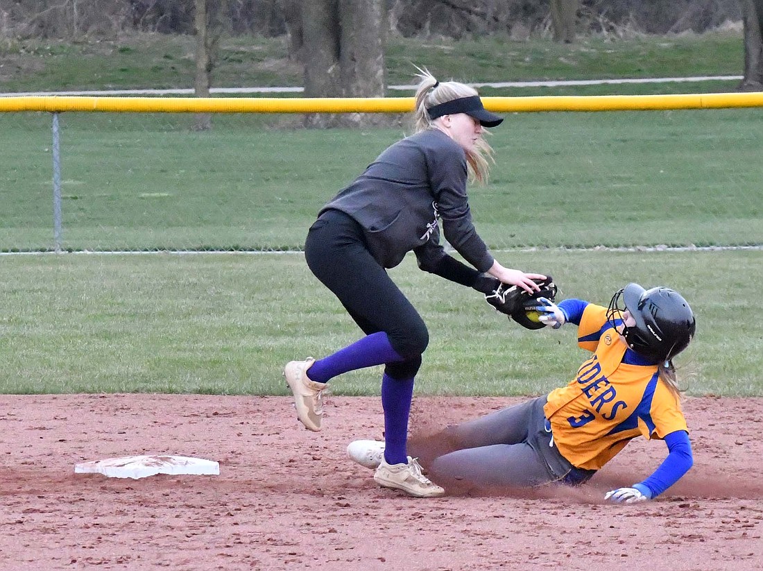 Fort Recovery High School shortstop Cali Wendel tags out Memorial’s Cadence Hirschfeld as catcher Kylie Post gunned her down to prevent a stolen base March 28. The next two games for the Indians were canceled due to weather. (The Commercial Review/Andrew Balko)