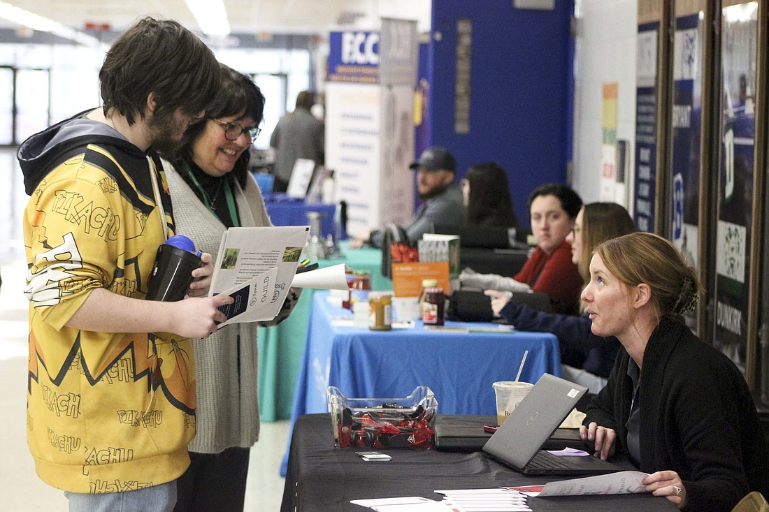 Jay County High School senior Kadyne Nusbaumer and job coach Robin Williams chat with Kristen Osborne of JR Manufacturing on Wednesday during the career fair portion of Signing Day. Jay County Junior-Senior High School students mingled with various industry partners about potential internships and summer and full-time employment. (The Commercial Review/Bailey Cline)