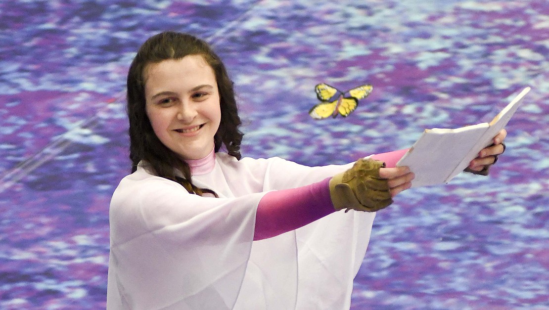 A butterfly flies out of Cherish Butler's book Sunday afternoon at the conclusion of the winter guard's performance Sunday during the Jay County High School spring band concert. The event included a silent auction. An online auction in support of the band program is open at brickerauctioncompany.hibid.com. (The Commercial Review/Ray Cooney)