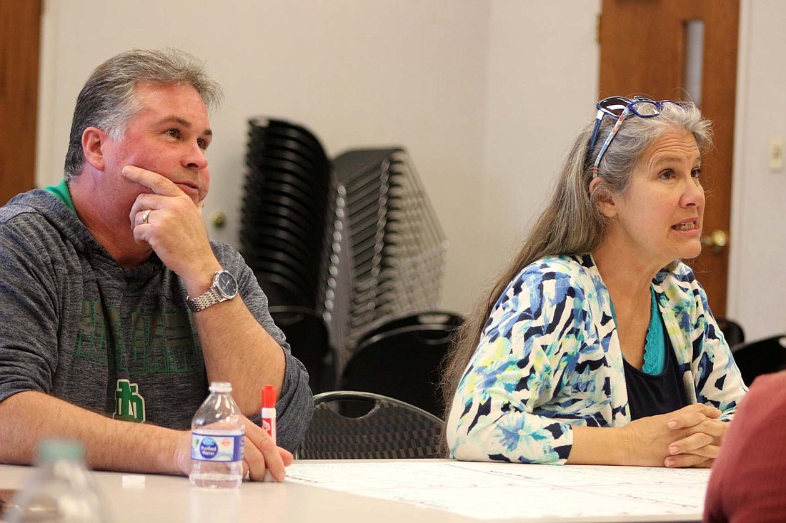 Jay County Commissioner president Chad Aker and Jay County Council vice president Cindy Bracy share their brainstorming ideas Tuesday at Jay County Public Library. East Central Indiana Regional Planning District hosted a public form at the library for aiding in the creation of its five-year Comprehensive Economic Development Strategy (CEDS) plan for Jay, Blackford, Delaware and Grant counties. (The Commercial Review/Bailey Cline)