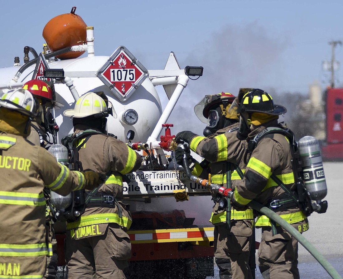 Firefighters from the Portland, Redkey and Bryant departments underwent training Saturday afternoon for how to handle propane leaks. Pictured, firefighters work on injecting water into a leaking propane tank during the training session led by Responder Training Enterprises in the Pioneer Warehousing parking lot, 1617 N. Meridian St., Portland. (The Commercial Review/Ray Cooney)