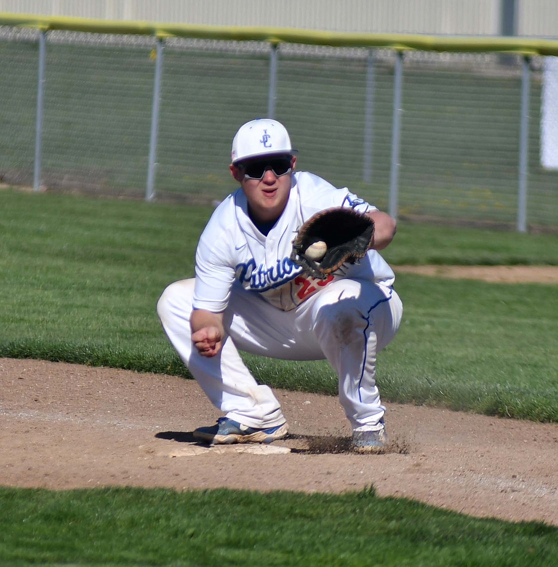 Jay County High School first baseman fields a throw from the pitcher during the Patriots’ 7-3 victory over the Centerville Bulldogs on Saturday. Jay County split a doubleheader with Centerville to secure their first win of the season. (The Commercial Review/Andrew Balko)