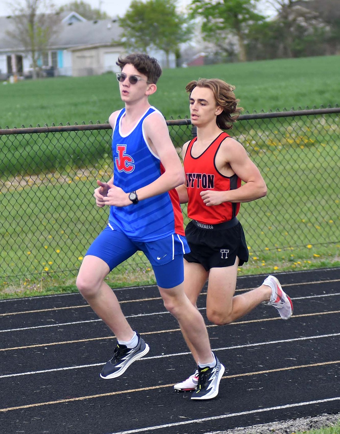 Jay County High School freshman Caleb Garringer shields off his opponent from Bluffton during the 1,600-meter run at West Jay Elementary School. (The Commercial Review/Andrew Balko)