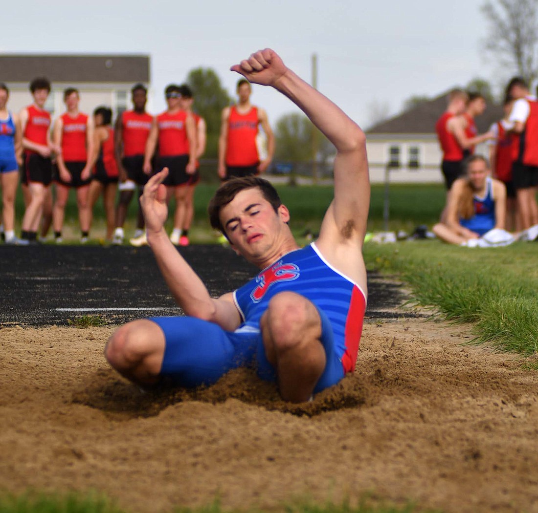 Jay County High School sophomore Peyton Yowell lands into the sand pit for the long jump at West Jay Elementary School during the Patriots’ meet against Bluffton. (The Commercial Review/Andrew Balko)