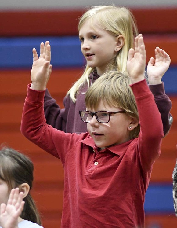 Asher Sharp (foreground) and Callie Huftel (background) of East Elementary School perform during Thursday morning’s rehearsal for the first grade spring program at East Jay Elementary School. The program included various songs to complement the story “The Day the Crayons Quit.” (The Commercial Review/Ray Cooney)