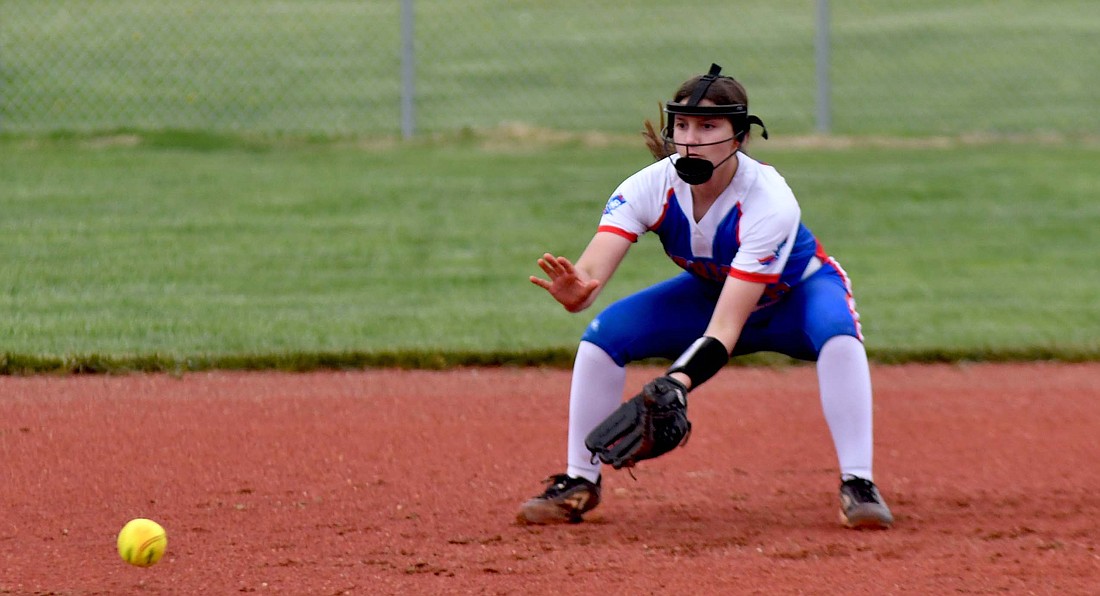 Jay County High School freshman Carley Trinidad fields a ground ball at shortstop during the Patriots’ 3-2 loss to the Madison-Grant Argylls on Friday afternoon. Trinidad, who was filling in at shortstop for Hallie Schwieterman, drove in Jay County’s second run in the fifth inning by hitting a line drive off of the pitcher with the bases loaded. (The Commercial Review/Andrew Balko)