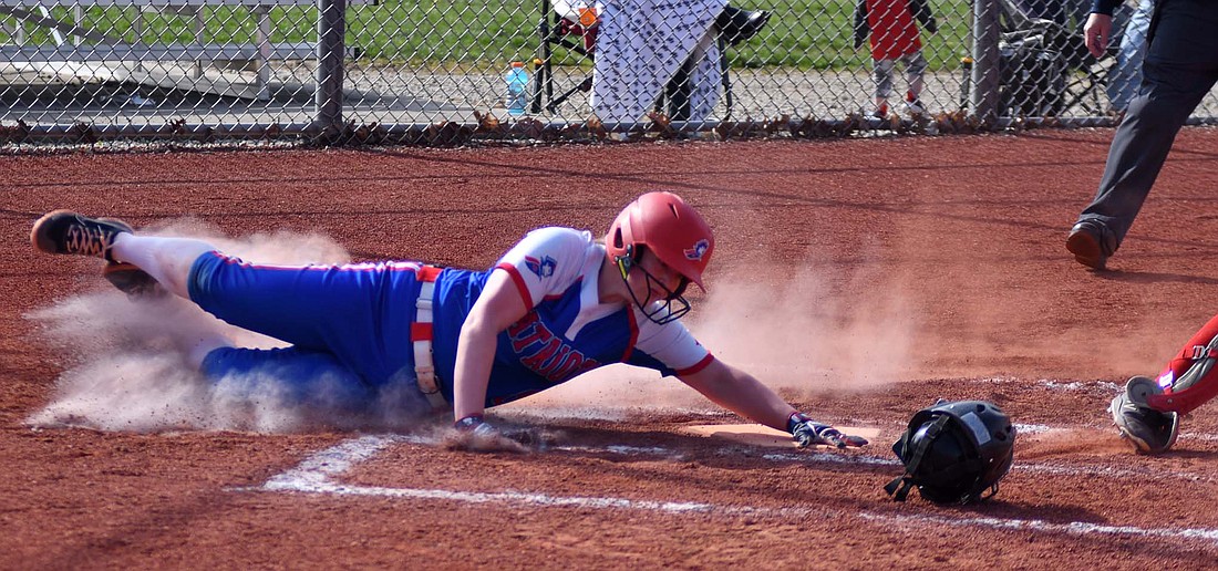 Jay County junior Jaelynn Lykins slides to avoid a potential tag at home plate to score the first run of the Patriots' 9-4 win over Wapahani on Monday. (The Commercial Review/Andrew Balko)