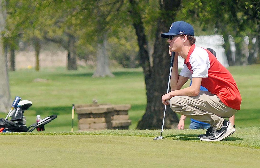 Jay County High School junior Luke Fugiett studies a green at Winchester Golf Club during the Winchester Invitational on Saturday. Fugiett shot a 104 on the day, which did not affect the Patriots’ team score of 345 strokes that placed seventh at the invitational. (The Commercial Review/Rick Reed)