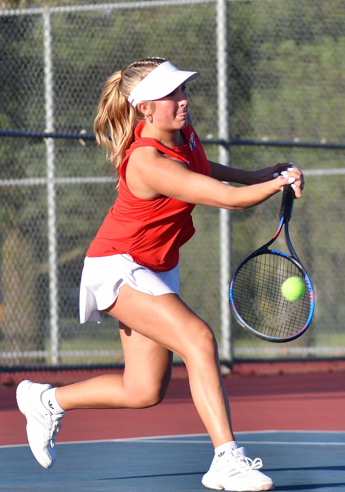 Jay County High School senior Maggie Dillon hits a forehand in the No. 3 singles match against Muncie Central’s Andrea Lopez during Tuesday’s 4-1 victory. (The Commercial Review/Andrew Balko)