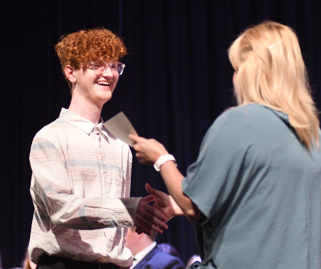 The Dunkirk Kiwanis Club Scholarship went to Hayden Hardman during Jay County High School Honors Night on Monday. Pictured, Hardmon accepts the honor from guidance counselor Kristin Millspaugh. Hardman also received the Spanish Award and Spencer G. Calvert Memorial Scholarship. He also earned an academic honors diploma. (The Commercial Review/Ray Cooney)