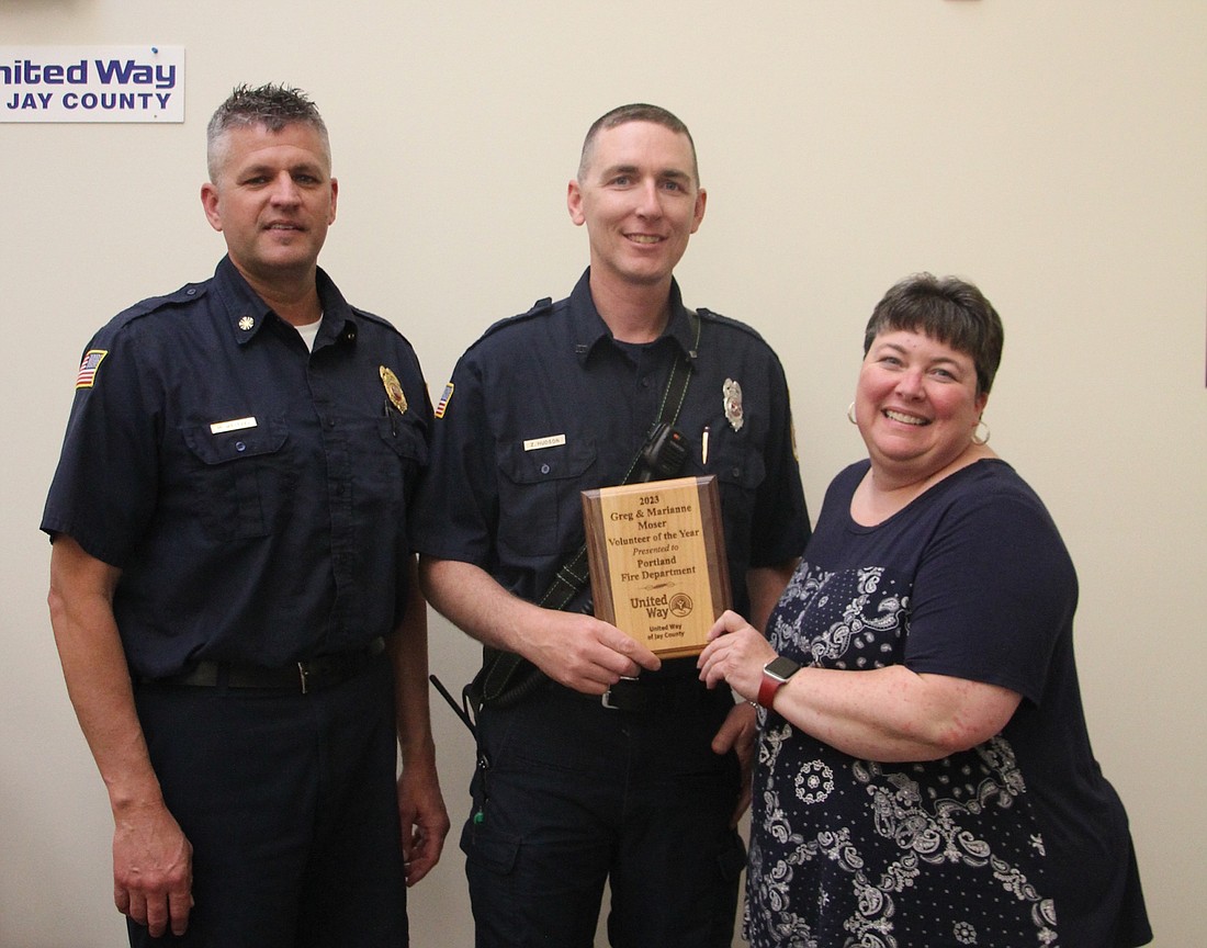 United Way of Jay County held an event Wednesday to celebrate a successful 2023-24 annual campaign and present several awards. Pictured, campaign chair Traci Gross presents the Greg and Marianne Moser Volunteer of the Year Award to Mike Weitzel and Zach Hudson of Portland Fire Department, which earned the honor for organizing the inaugural Splashin’ with a Passion: Peggy’s Plunge fundraiser in honor of the late Peggy Atkinson. Weitzel also was honored with the Vicki Tague Community Impact Award for his years of service with United Way and various other organizations. (Photo provided)