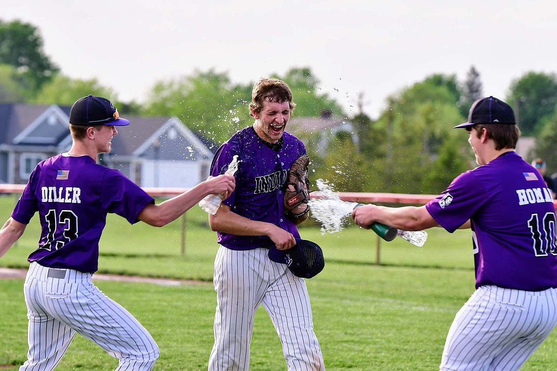 Fort Recovery High School senior Alex Dues gets doused with water by Mason Diller and Caden Homan after throwing the first perfect game in Fort Recovery baseball history on Thursday in a 4-0 victory against New Bremen. (Special to The Commercial Review/Kim Wendel)