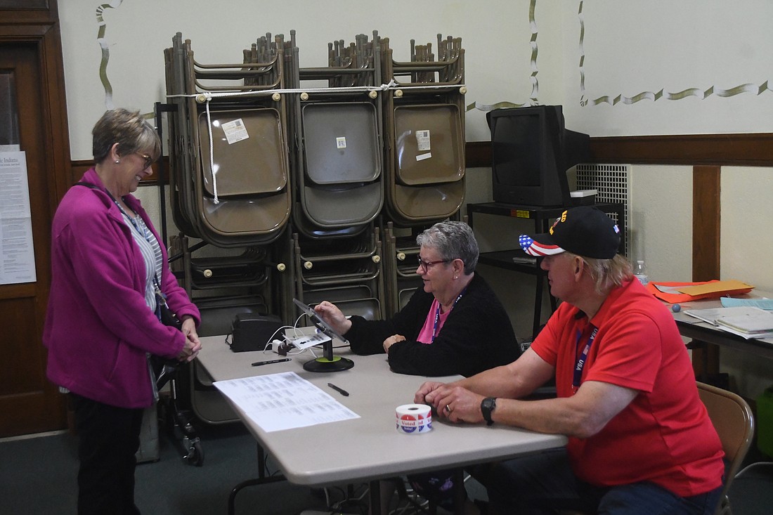 Poll worker Virginia Burkey (right) helps Patricia Walker check in to vote Tuesday morning at Jay County Courthouse. Voter volume was low at the courthouse early Tuesday, with only about 10 voters having passed through as of 8 a.m. Polls were open until 6 p.m. Tuesday. (The Commercial Review/Andrew Balko)