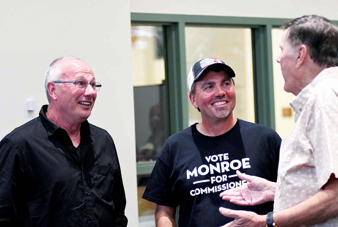 Doug Horn and Duane Monroe, who won GOP commissioner races Tuesday, chat with John Coldren during a gathering of Republicans on Tuesday night at John Jay Center for Learning. Horn defeated former commissioner Mike Leonhard while Monroe topped incumbent Brian McGalliard. (The Commercial Review/Ray Cooney)