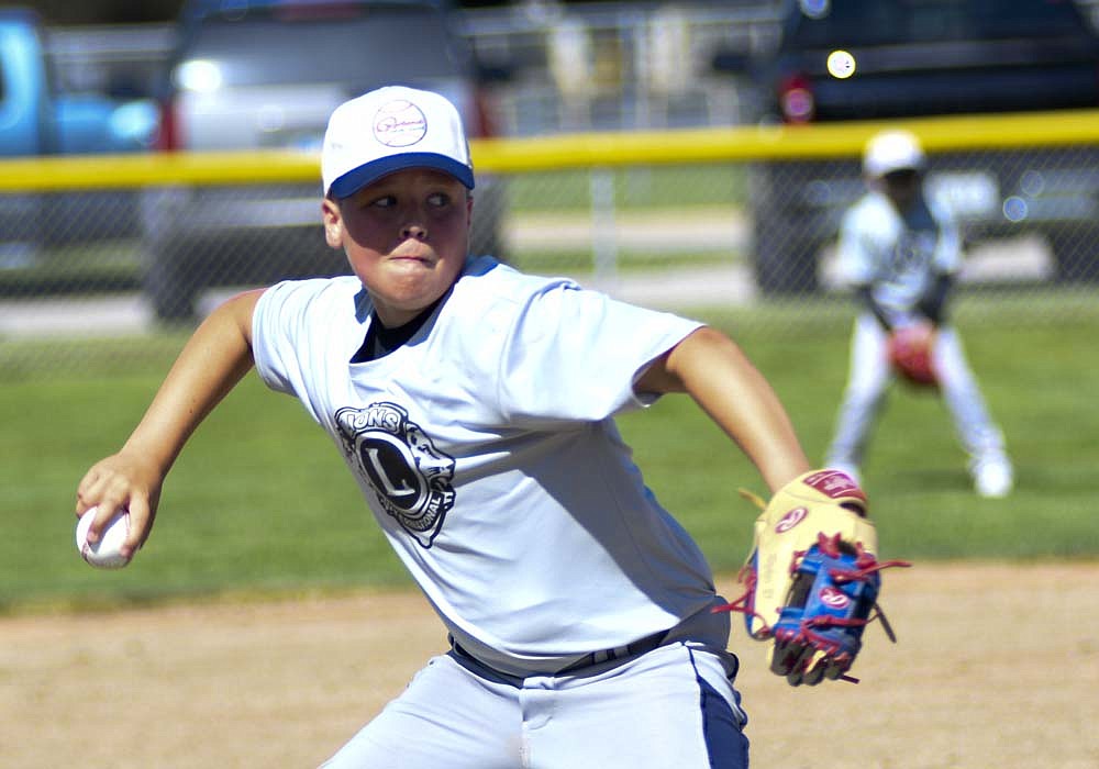 Portland Lions Club pitcher Ryker Price prepares to toss a pitch Saturday during his team's Portland Junior League game against Portland Optimist Club. Saturday marked opening day for Portland Junior League. (The Commercial Review/Ray Cooney)