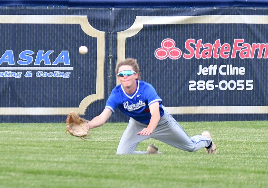 Jay County High School left fielder Jackson Edwards lays out for a fly ball in the fifth inning against the Delta Eagles on Monday. The ball just dropped in for a base hit to drive in a run and extend the lead to two runs. Delta beat JCHS 8-4 in the game. (The Commercial Review/Andrew Balko)