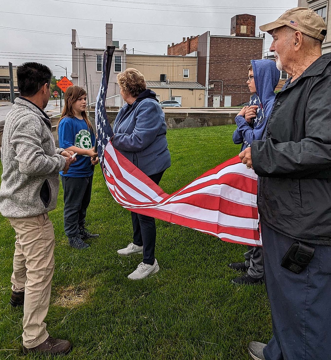 Members of the  Portland Evening Optimist Club and BSA Scouts Troop 202 of Jay County put up new flags Tuesday around Jay County Courthouse. Pictured from left are Bobby Ruiz,  Blaine Finch, Linda Aker, Jason Sims and Ferrell Blazer. (Photo provided)